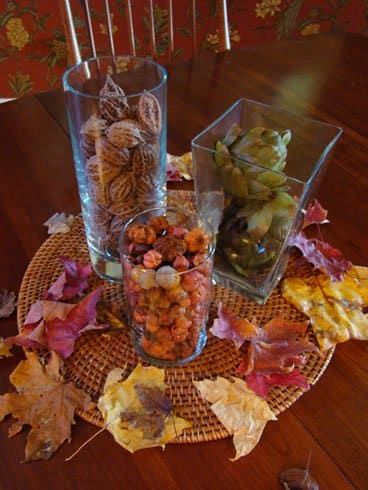 Nueces enteras o mitades de cáscara de nuez en un jarrón forman una hermosa pieza central de otoño.