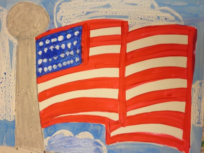 Poslikava ameriške zastave z akrilno barvo. Charisse je svojemu slikanju z ameriško zastavo dodala oblake. Oblaki so bili narejeni z oljnimi pasteli, nato pa so na nebo dodali še akvarel. Čudovito delo!