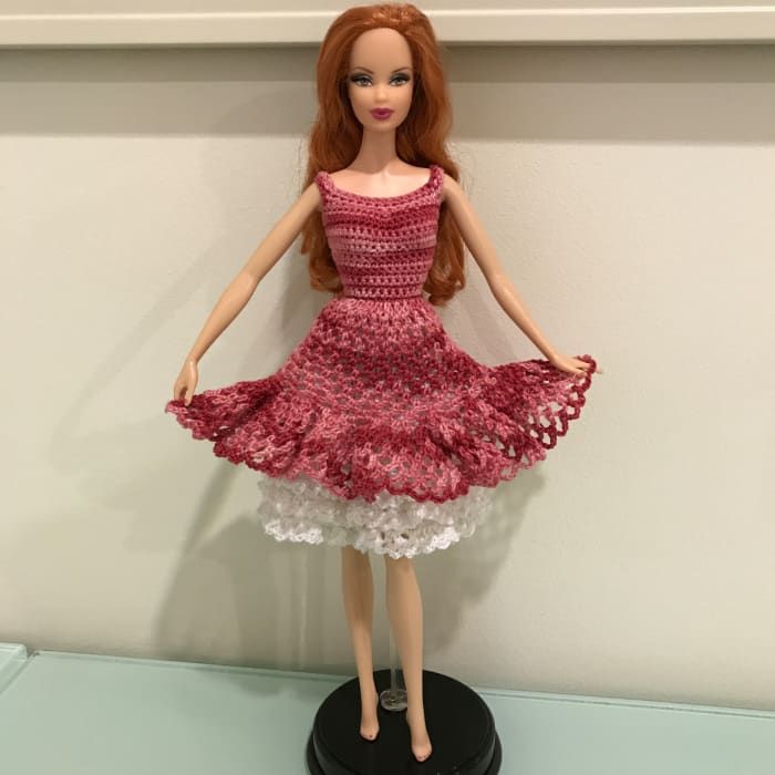 Barbie sosteniendo la falda ancha con sus manos